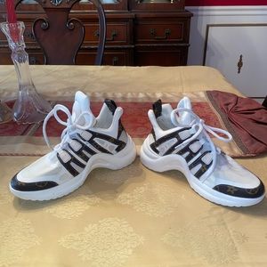 White sneakers with brown canvas design.